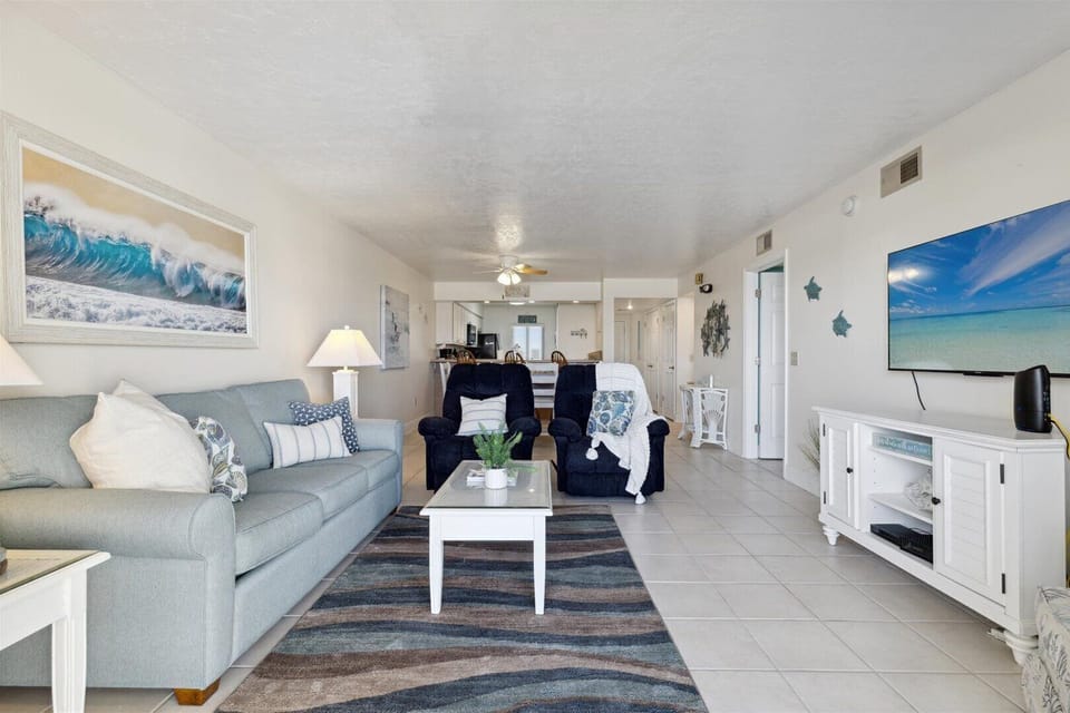 Relaxing living area with plush seating and ocean-inspired decor.