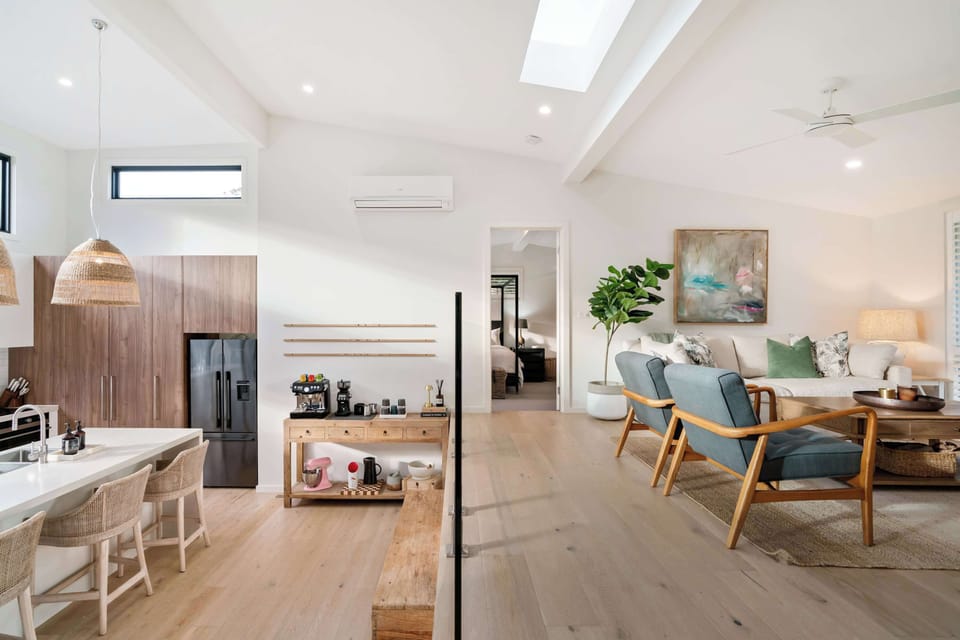 As you enter the home, you are on the top landing with bedrooms, bathrooms, laundry and second living. This overlooks the bottom floor.