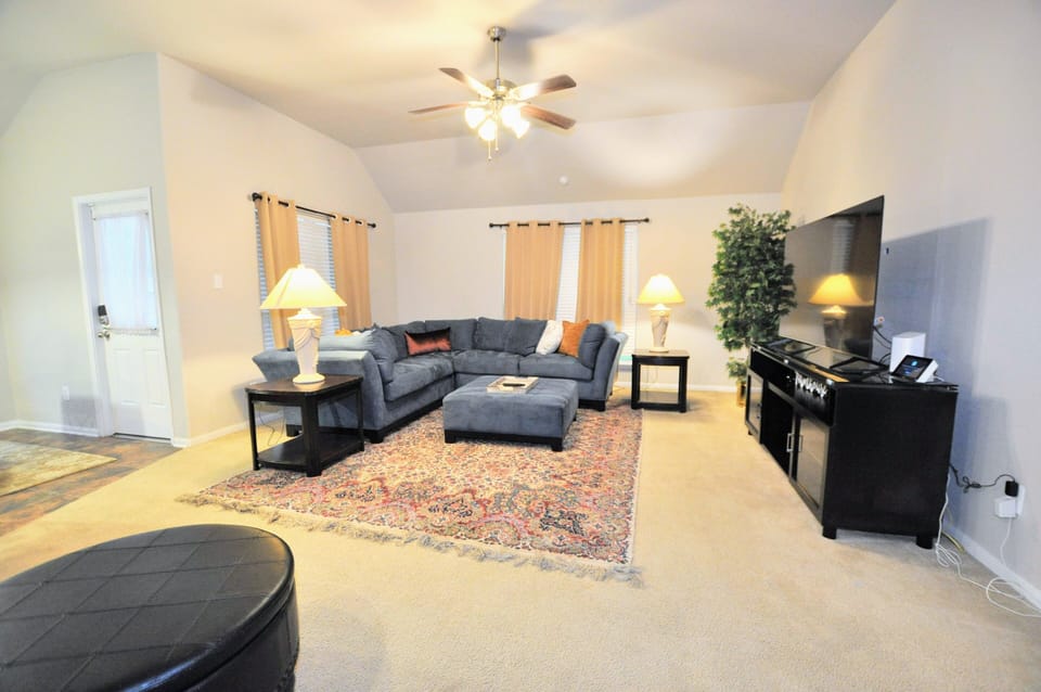 Spacious living room with seating for 5 and a large 50+ inch TV with Youtube TV.