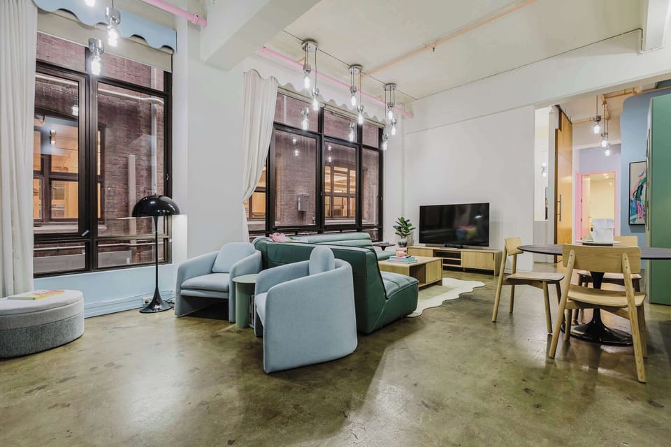 LIVING SPACE: Open and spacious with 4m ceilings, expansive windows, and a cosy electric fireplace. This vibrant hideaway captures the essence of Melbourne charm. A colourful retreat made for slow mornings and soft landings after lively nights out.