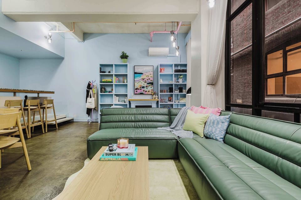 LIVING SPACE: Open and spacious with 4m ceilings, expansive windows, and a cosy electric fireplace. This vibrant hideaway captures the essence of Melbourne charm. A colourful retreat made for slow mornings and soft landings after lively nights out.