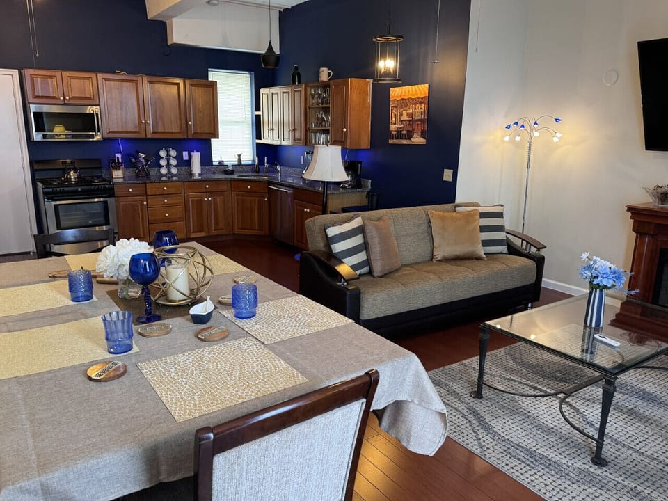 Living room, apartment # 3 : 2 pull out Sofas ( full size) , ceiling, fan, TV, dining area, AC on window.