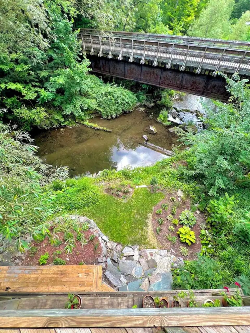 On the balcony looking down at the garden and river.