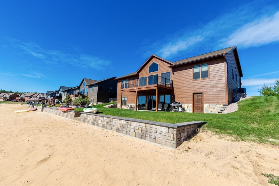 The beach and backyard area of the home.