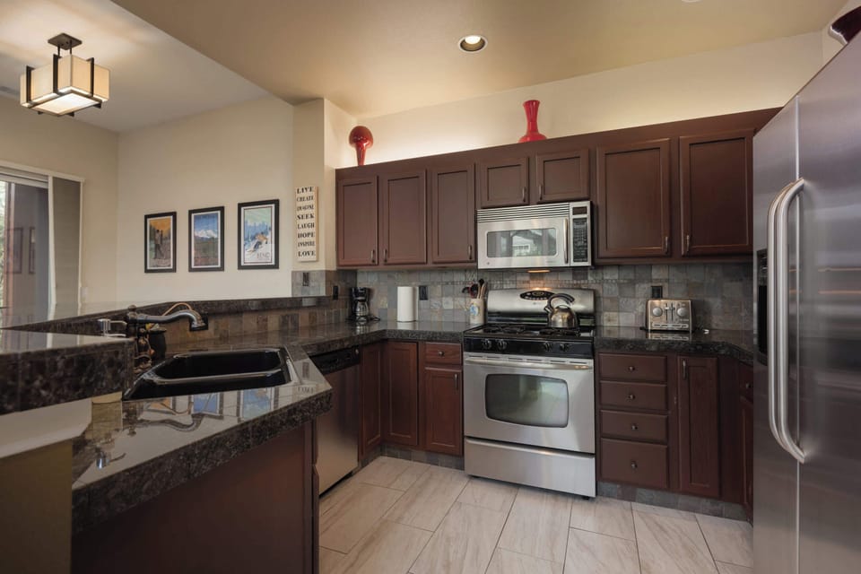 The chic, open kitchen offers ample space & every home comfort