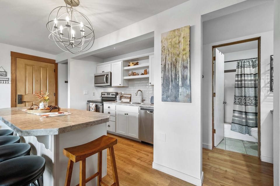 The sleek kitchen offers ample counter space & all the comforts of home