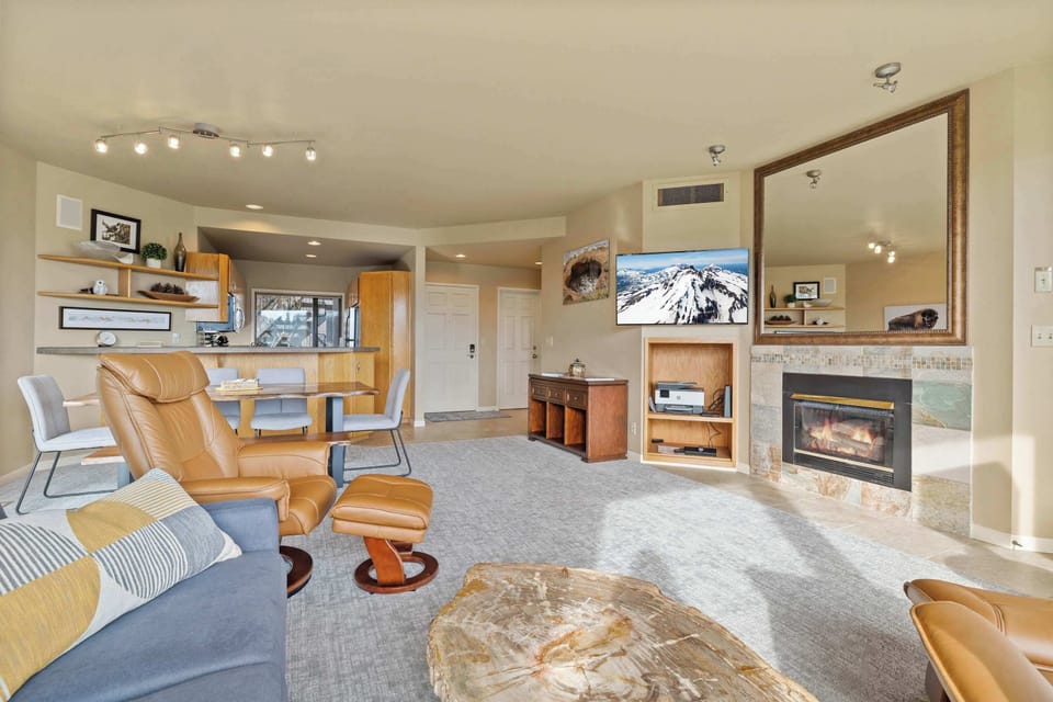 Bright open living space with sofa sleeper, gas fireplace, and Smart TV