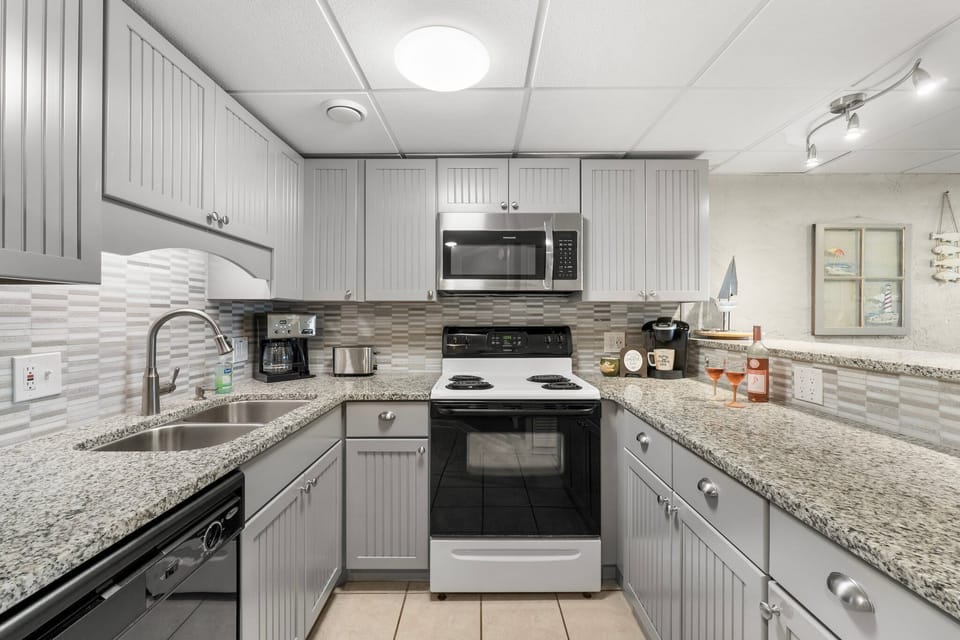 Bright, fully equipped kitchen with granite counters and plenty of space for easy vacation meals