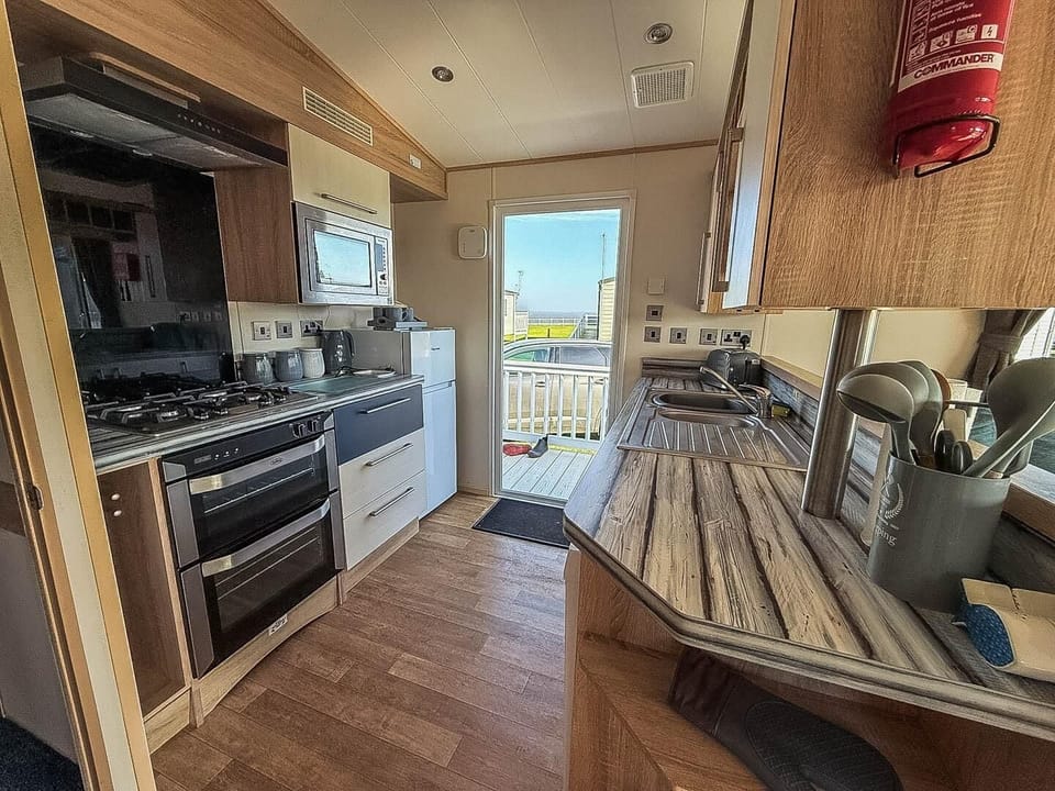 Spend quality time with your family on holiday at Hopton Holiday Village Norfolk, where the kitchen area of a static caravan makes self-catering a breeze after a day at Great Yarmouth beach.