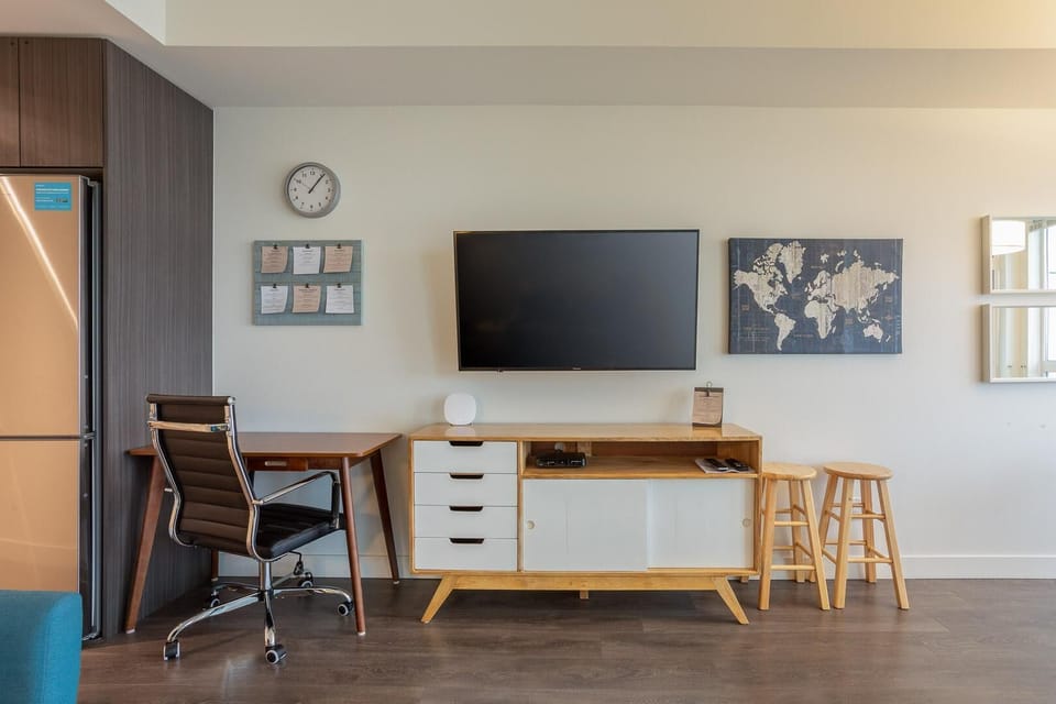A bright and airy layout showing the integrated office desk area tucked seamlessly into the living room corner.