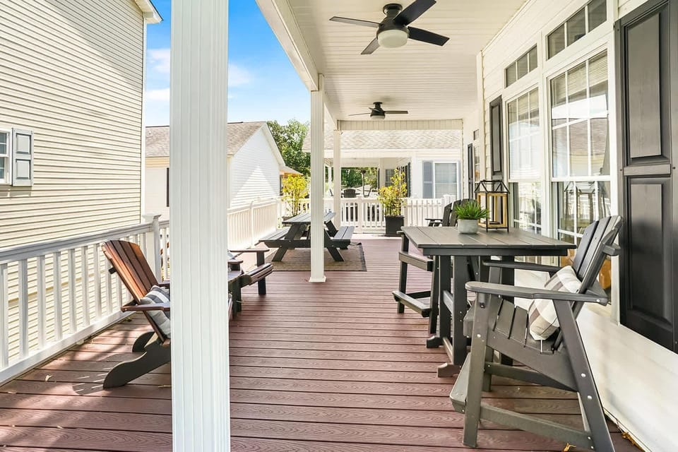 Spacious covered porch with cozy seating and dining area