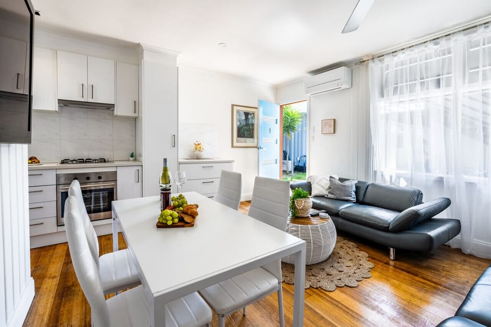 Open plan kitchen living and dining with aircon and fans
