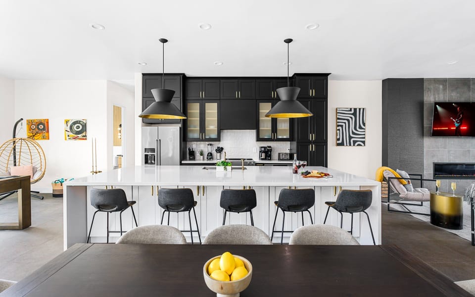 Fully Equipped Kitchen featuring stainless-steel appliances, a kitchen island with seating for 5 guests, a dining table with seating for 8 guests and a pool table.