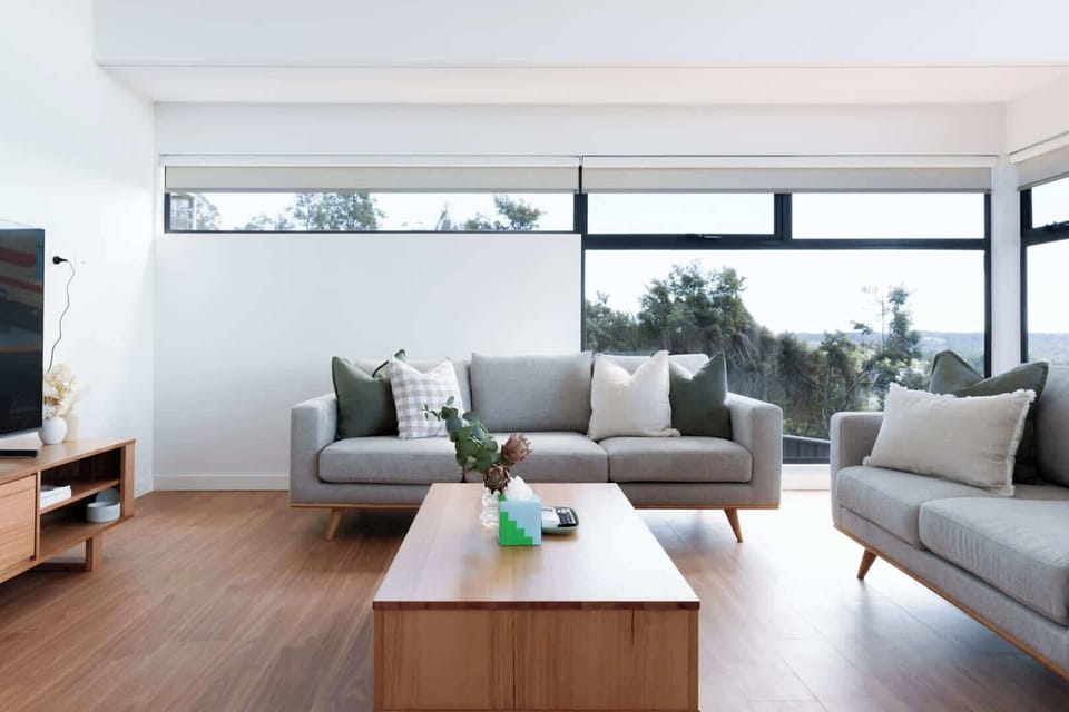 Relax on the comfy sofa with a soft throw, enjoy the big TV, and take in the peaceful nature views outside. The wood table adds the perfect Australian touch!