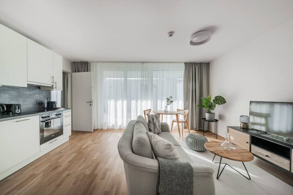 Step into the living room, where Arbio Designers` expertise shines through, creating a warm and inviting atmosphere, perfect for socializing or watching TV.