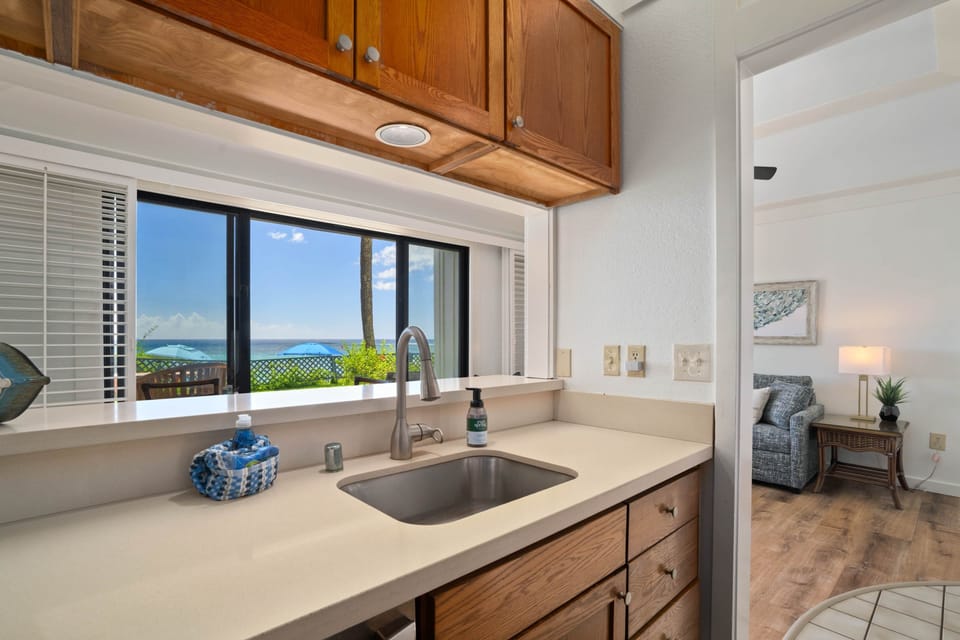Wash up with a view — this oceanfront kitchen lets you savor paradise from every angle.