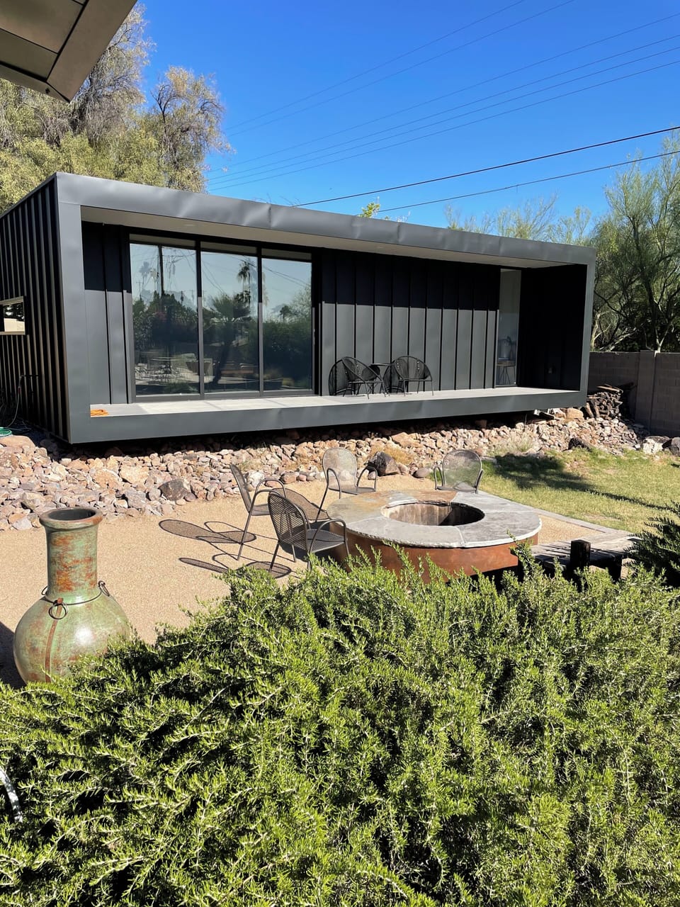 View of front of guest house, set over the wash and fire pit in back yard
