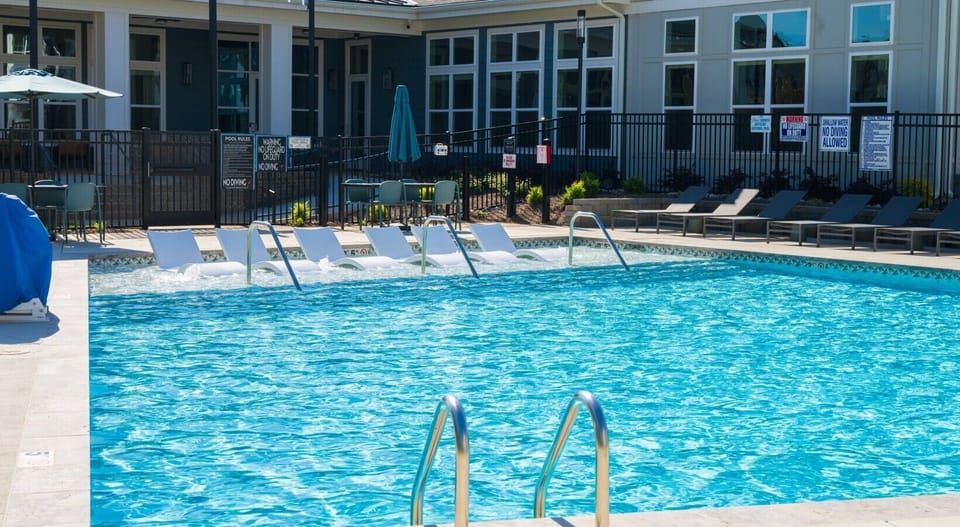 Outdoor swimming pool featuring a sun shelf and loungers