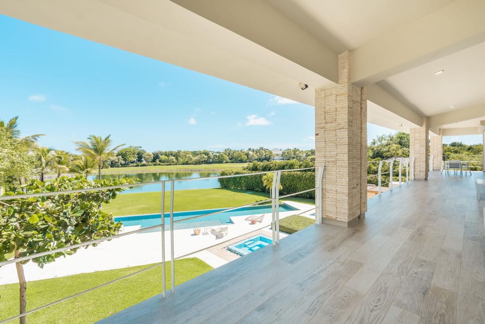 - Upper terrace with panoramic pool and lake views for morning relaxation  
- Spacious walkway connects outdoor living with serene nature scenery  
- Open design offers a breezy resort-style experience throughout your stay