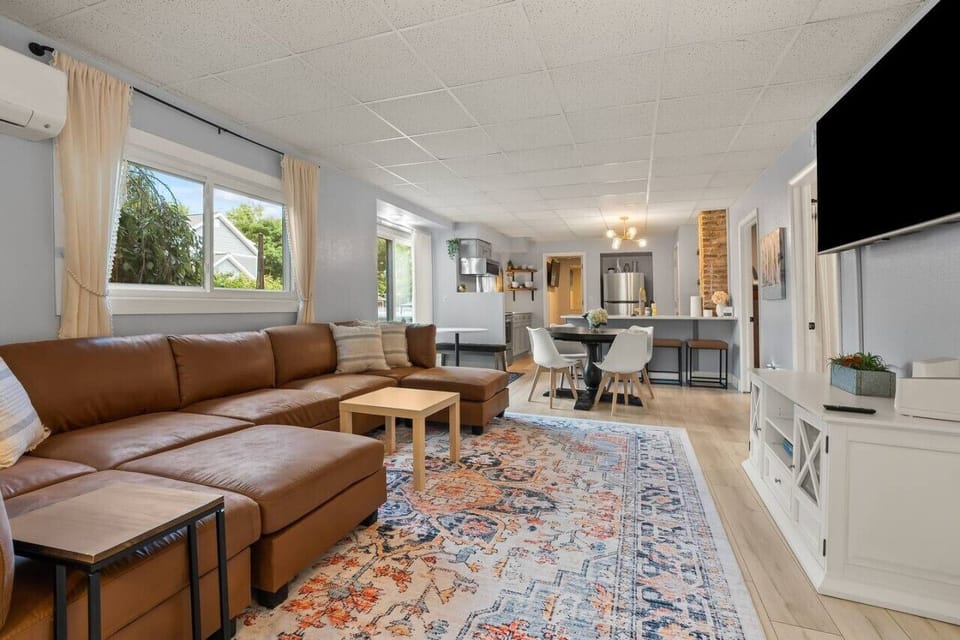 Relax in the spacious living room with a comfy couch and smart TV, the perfect spot to unwind after a day of adventures.