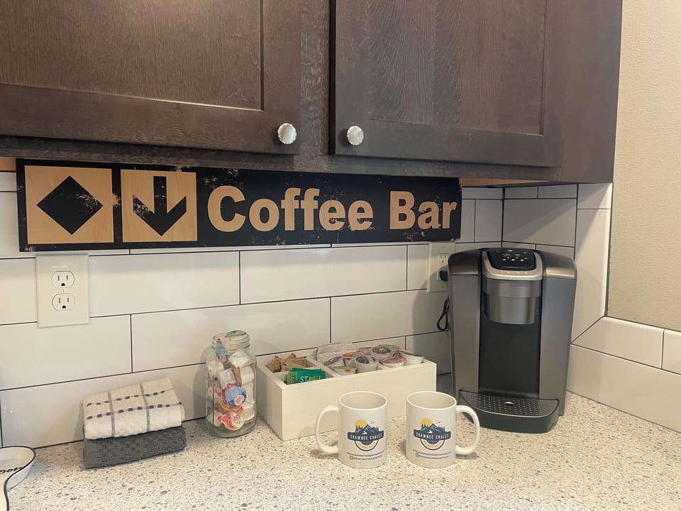 Coffee Bar with Keurig Single Cup Coffee Maker, Coffee Pods, Sugar, Creamer, Tea & Hot Cocoa. We also have a full sized coffee pot for those that have a favorite coffee that you want to bring. 