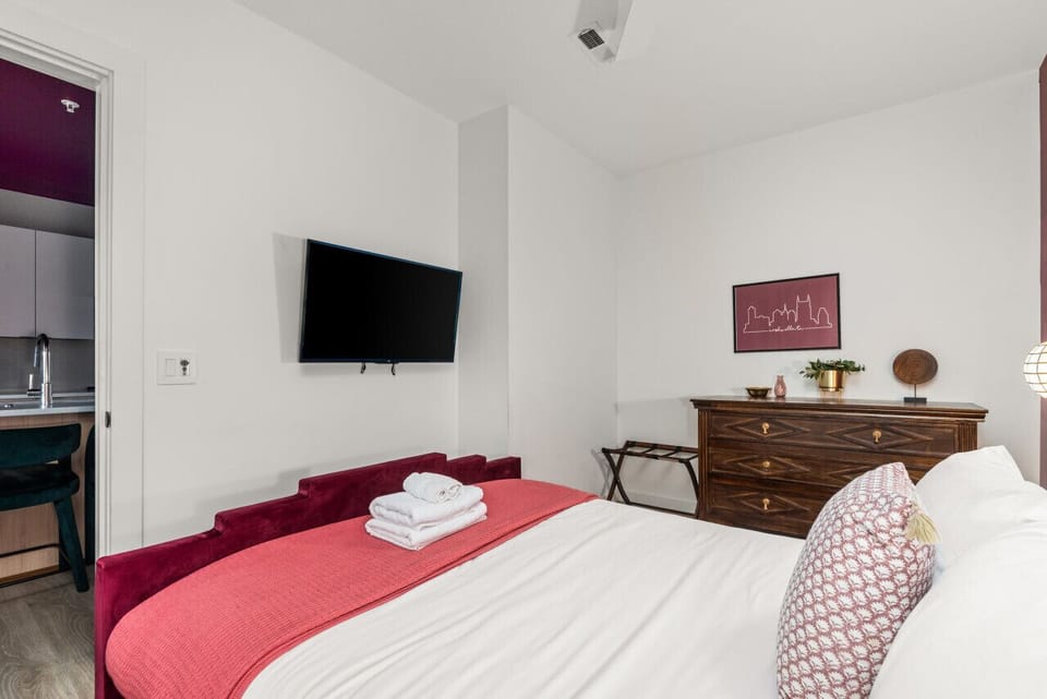 Third Bedroom: Queen-size bed with designer furnishings and smart TV.