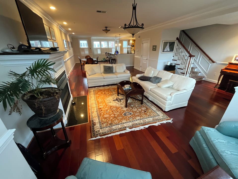 Living room with sofas, TV, fireplace and piano