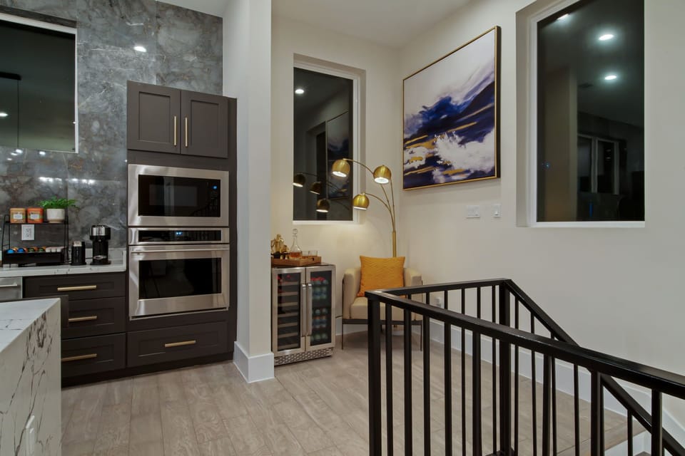 Enjoy cooking and entertaining in this modern kitchen with Monogram stainless steel appliances.
