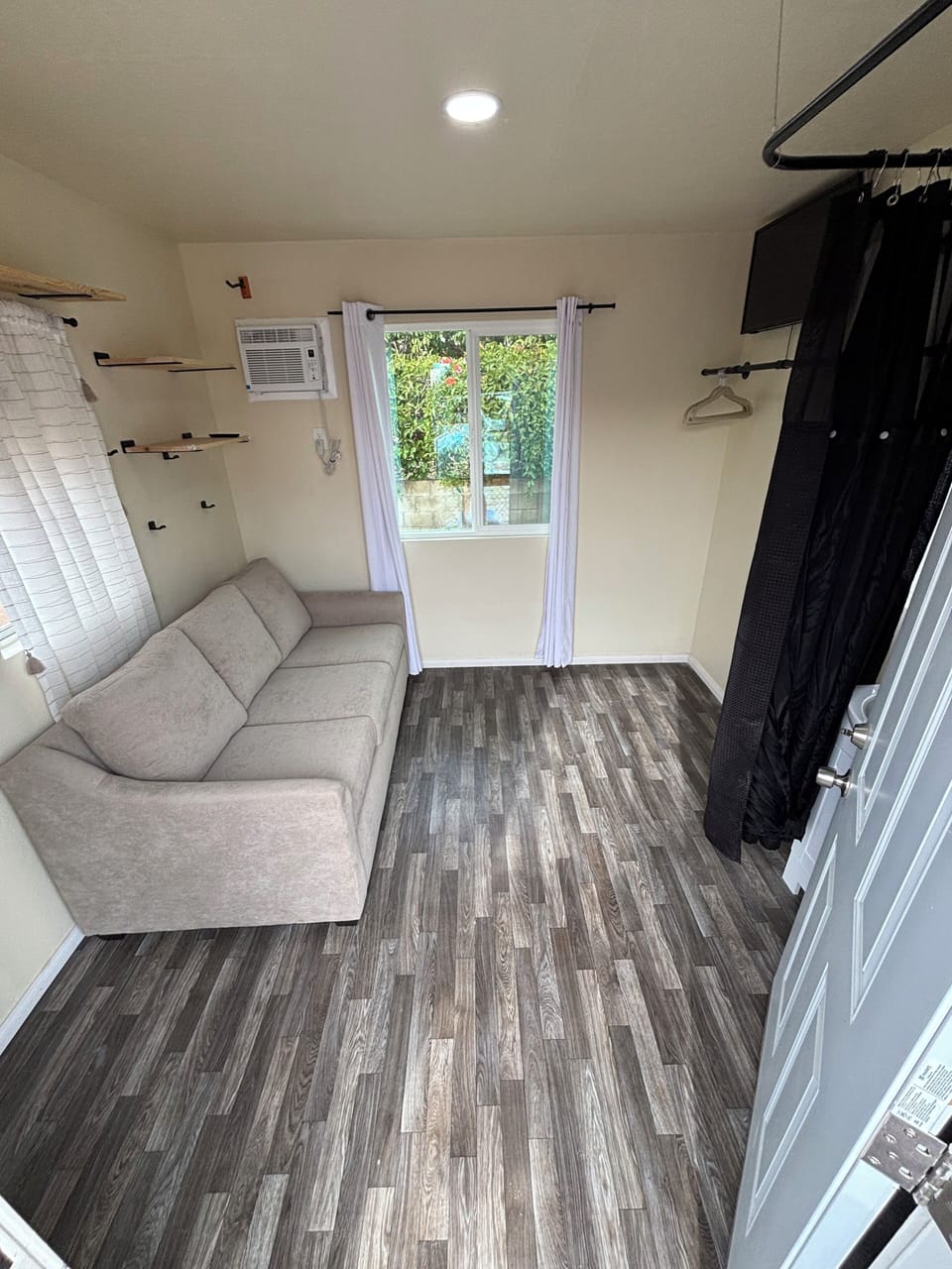 Light bright tiny home. Couch folds to full bed. Linens/pillows/towels provided.