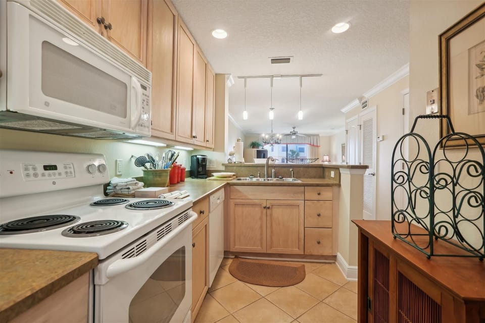 - Modern kitchen with updated appliances and bright cabinetry  
- Fully stocked with essentials for cooking and vacation dining  
- Perfect space for preparing breakfasts before heading to the beach

