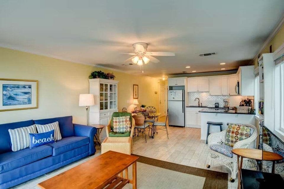 Open concept living area with stylish furnishings balcony access TV