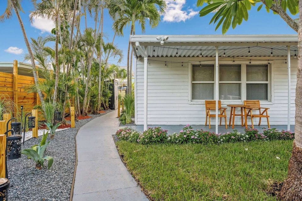 Step into this lush Florida yard, where swaying palms and sunny skies create the perfect setting for relaxation and outdoor enjoyment.