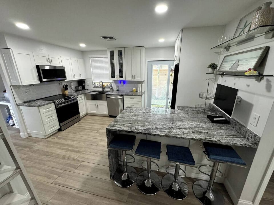 Cook and gather in this bright, airy kitchen, filled with natural light and modern touches for a warm and inviting atmosphere.