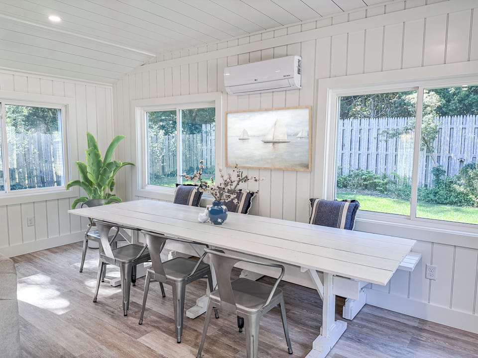 Large dining table in the sunroom for large meals or games.