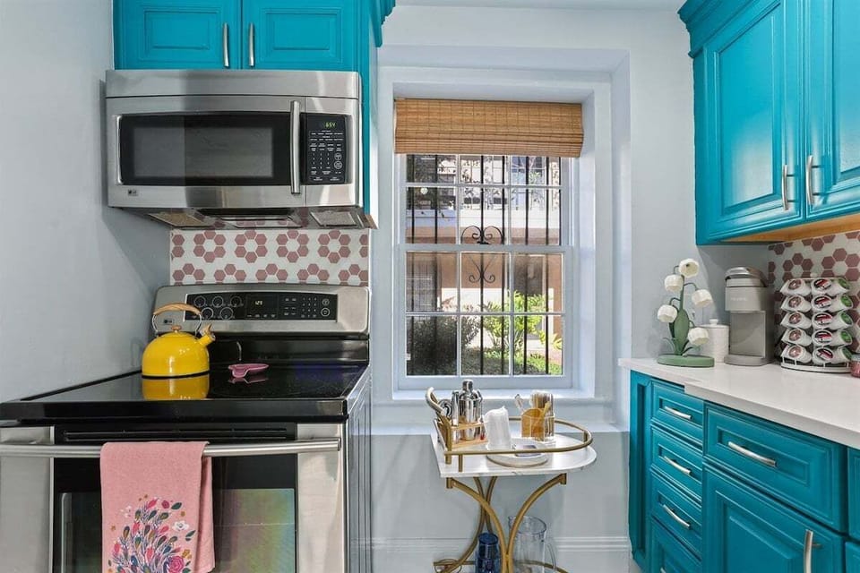 With bold turquoise cabinets, a cheerful yellow kettle, and the cutest coffee setup, this kitchen is a mood-lifter in every way.