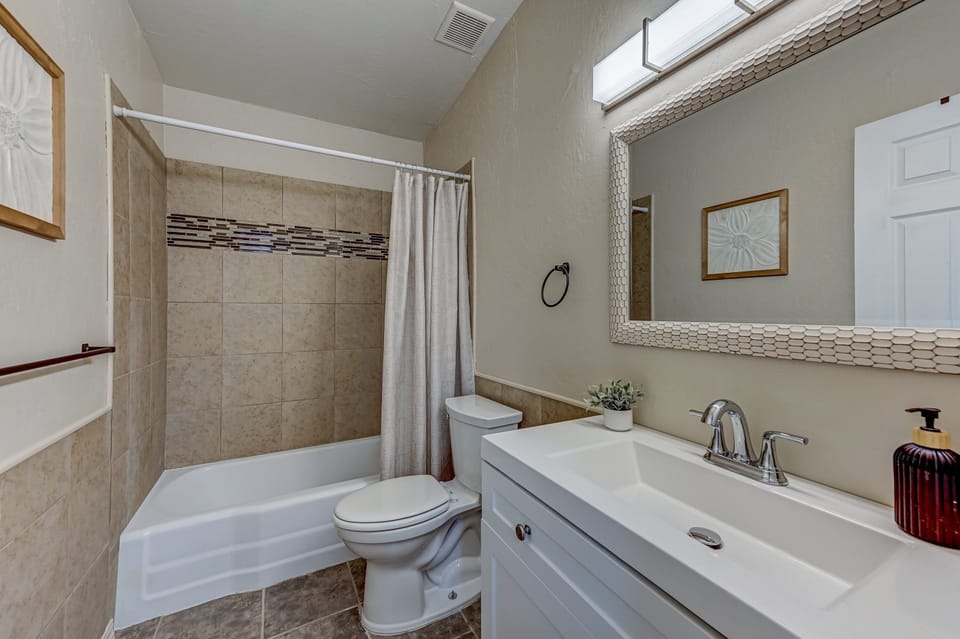 Shower bath combo with towel, toilet paper, soap, and shampoo provided for your convience.