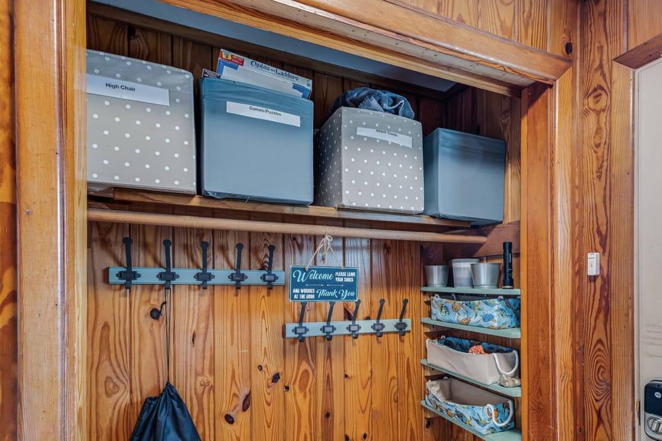 Discover an organized entryway with stylish storage bins for games and other items.