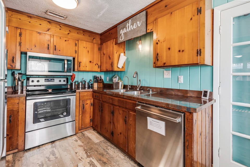 Kitchen with complete appliances spacious countertops for easy meal preparation.