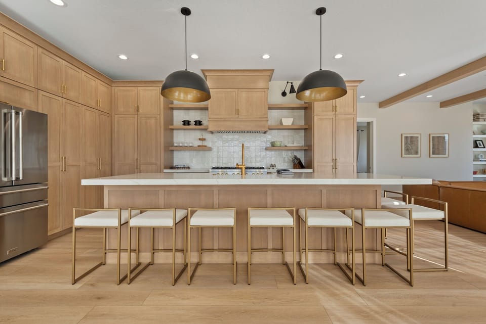 A massive island is the centerpiece of the large chefs kitchen