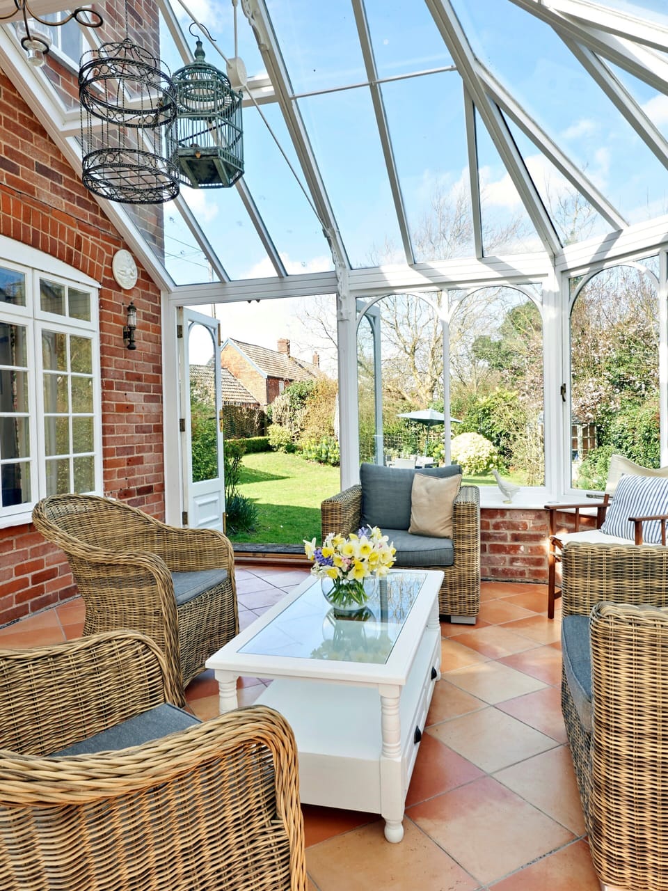 Sun filled conservatory with comfortable seating 
