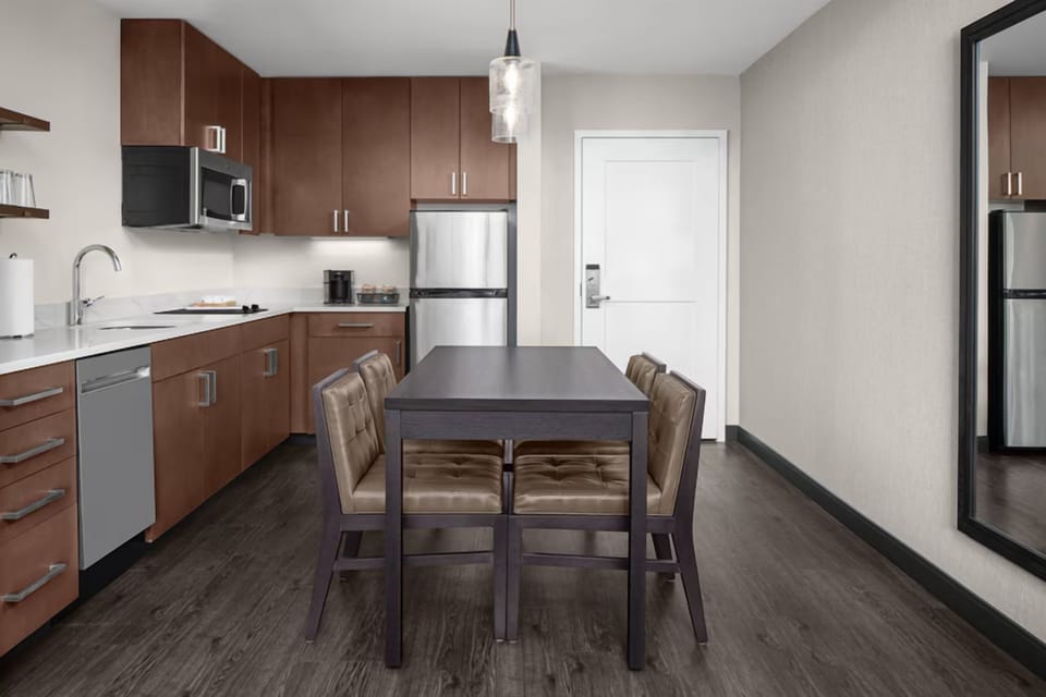 Cook and gather around the sleek table in this full kitchenette.