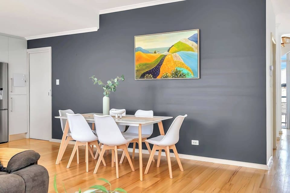 This modern, open-plan kitchen, living and dining area provides a comfortable setting for family gatherings and meals.
