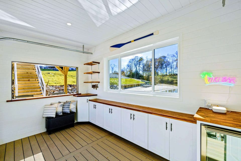 Boathouse - Interior bar area with countertop seating and views through oversized windows.