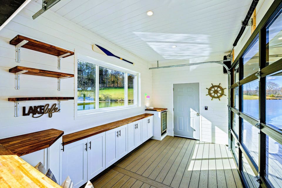 Boathouse - Lake-themed interior with counter space, nautical decor, and large windows.