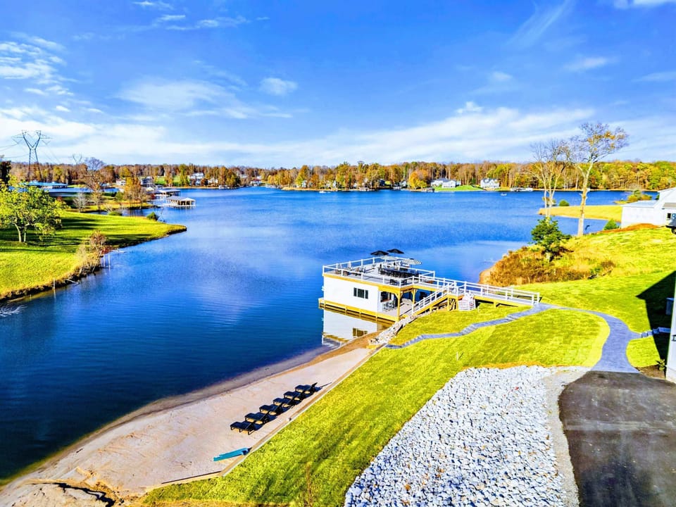 Beach - Wide view of the beach area with dock and lake beyond.