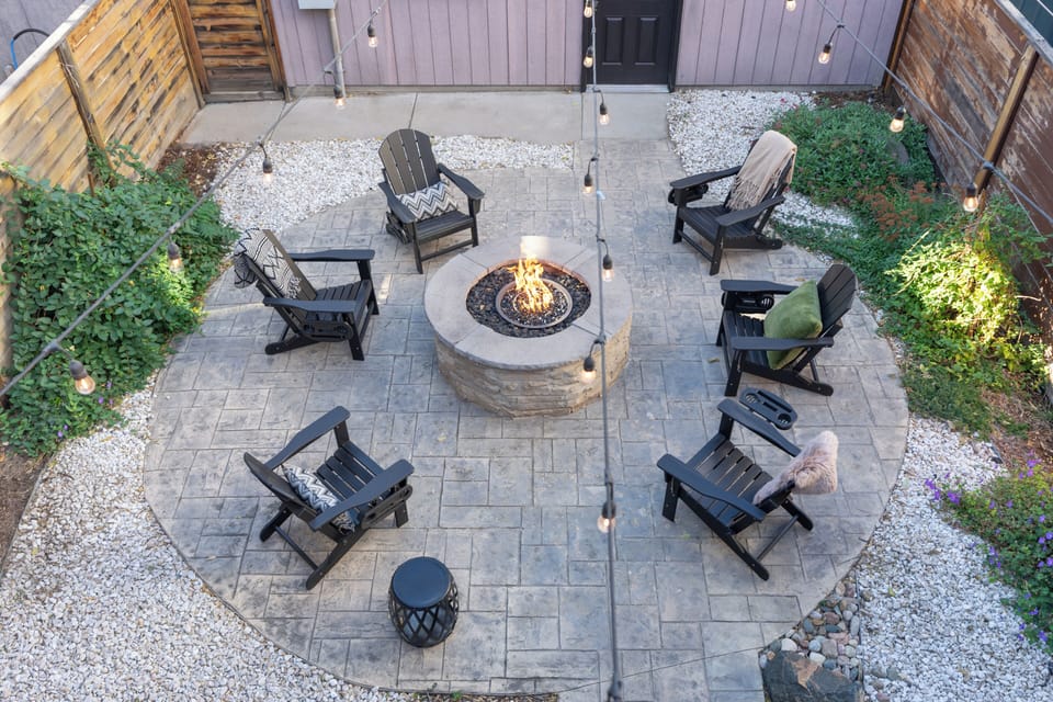 Private outdoor area with fire-pit, grill and lounge seating.