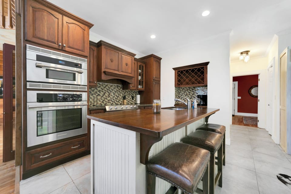 Our kitchen boasts elegant wooden cabinetry. moderm appliances, central island