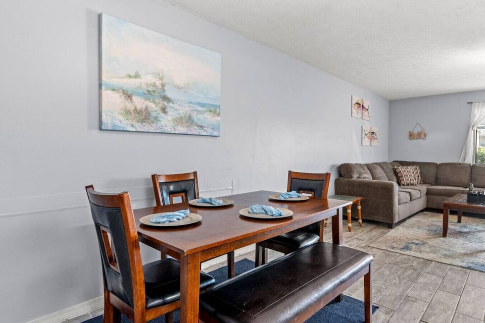 A stylish dining table for five, featuring a long bench on one side that comfortably seats two, creating a cozy and inviting space for meals and gatherings.