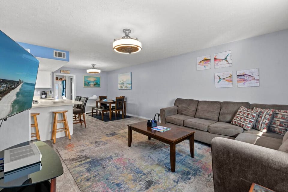 An open, bright living room filled with natural light, creating a spacious and airy atmosphere.