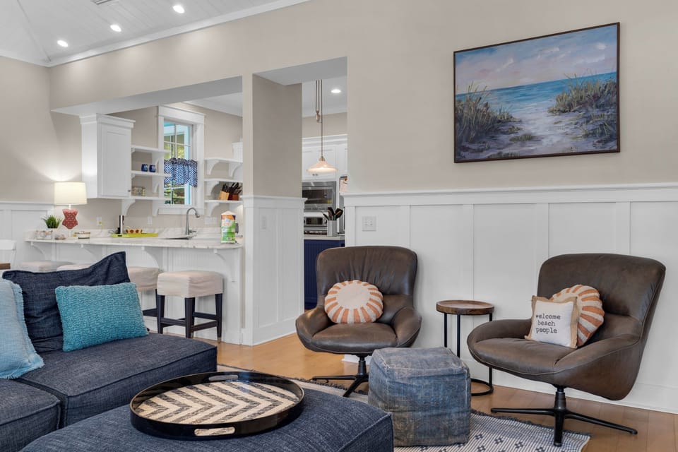 Unwind in your coastal-inspired living space where soft blues meet warm neutrals, creating the perfect spot to relax after beach days.